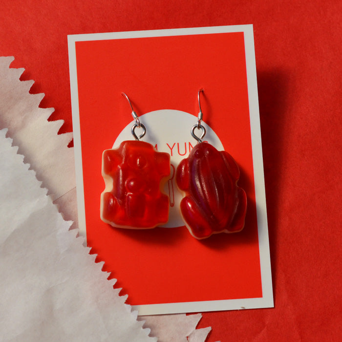 red lolly car and red lolly frog red and white strawberry and cream lolly novelty earrings made from resin on a red and white background