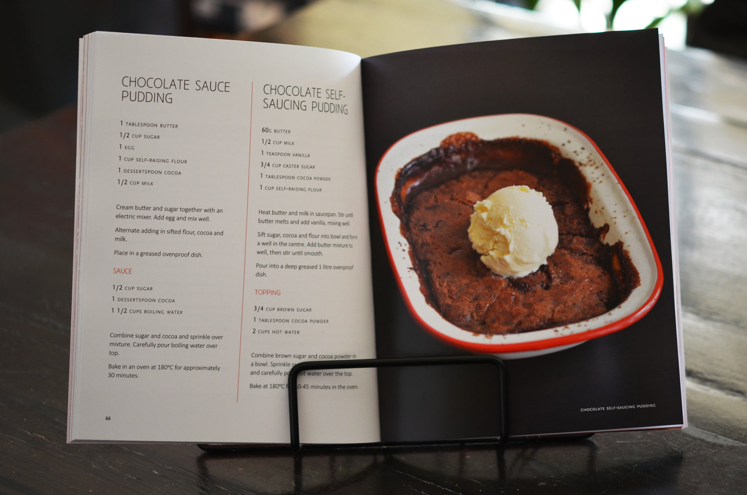 Recipe book opened on a cake stage showing a recipe of chocolate sauce pudding with a picture of a chocolate pudding with ice cream on the second page