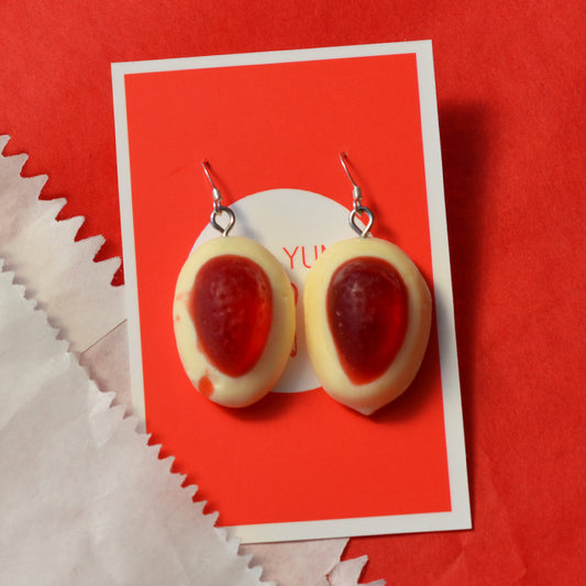 red and white strawberry and cream lolly novelty earrings made from resin on a red and white background